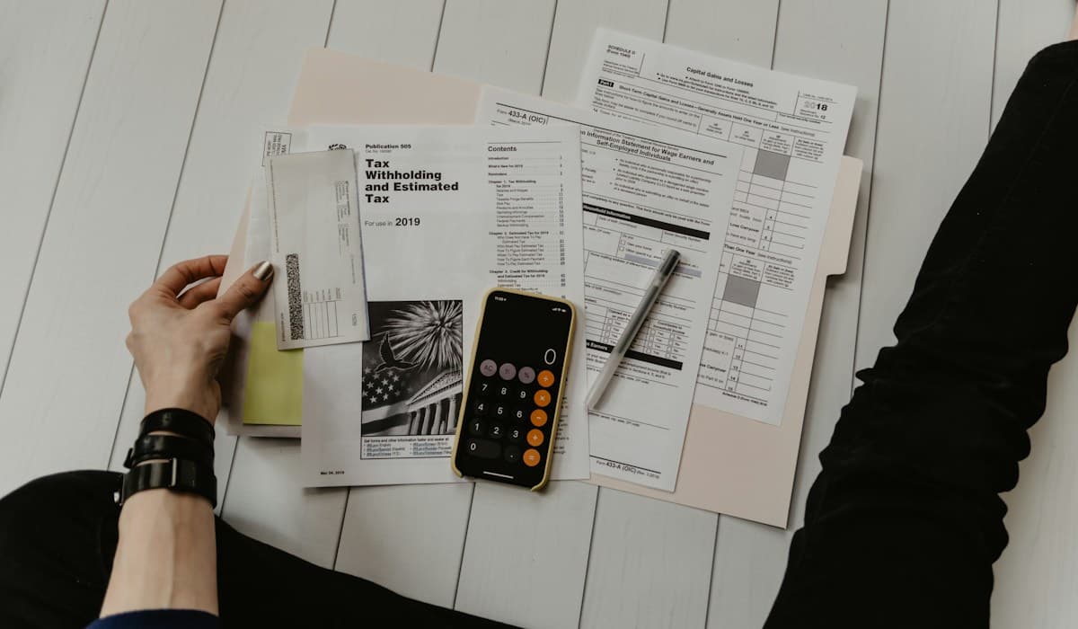 Reviewing financial paperwork with a calculator and pen